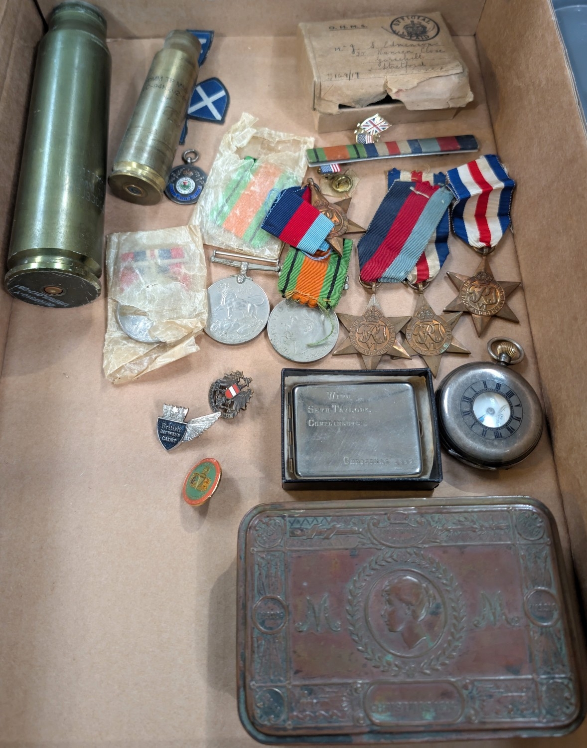 A group of five WWII medals, pocket watch, shells etc.