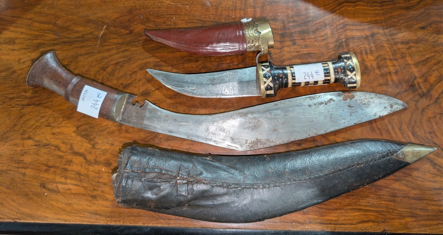 A Middle Eastern curved dagger with bone and horn handle, text to the ...