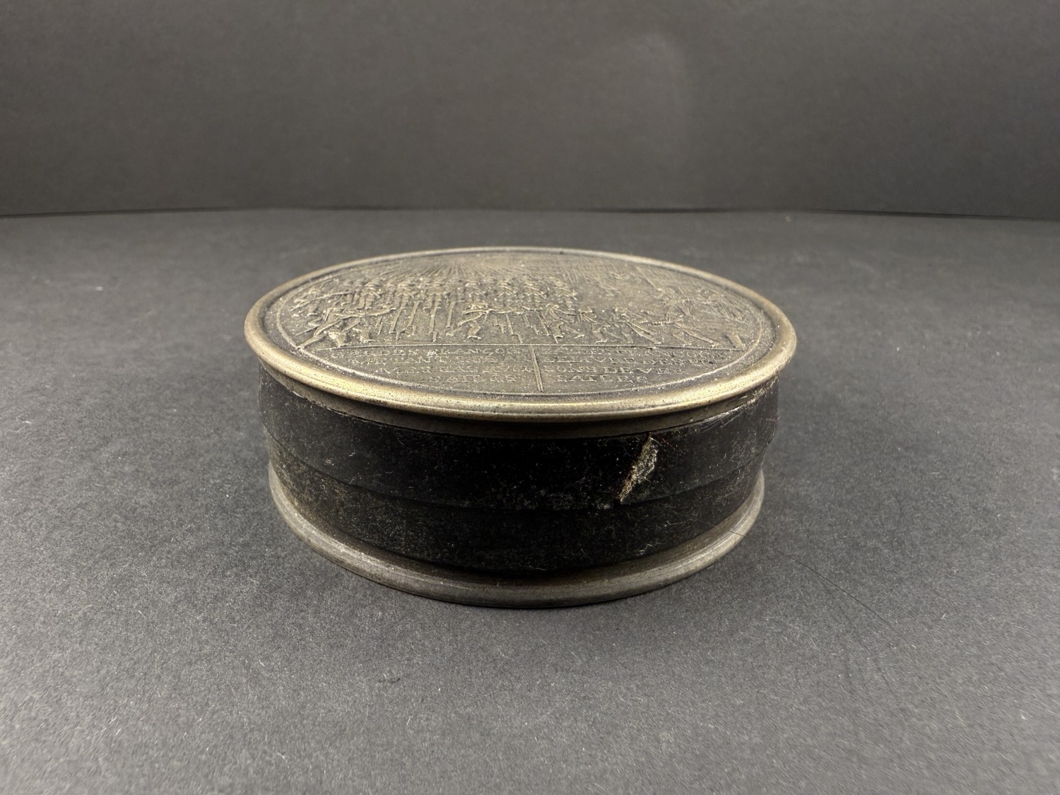 A modern bronze coloured metal circular snuff box with French military ...