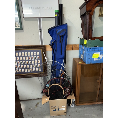 37 - A bag with fishing rods in tubes, various large fishing nets (wood and metal), and a shooting stick....