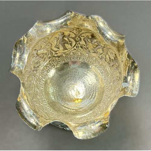 764 - An early 20th century Indian white metal pedestal bowl with wavy rim, embossed figural decoration, 4... 