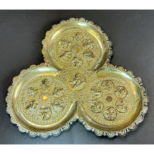 765 - An early 20th century Indian silver lobed dish with deities in relief, 7.3oz