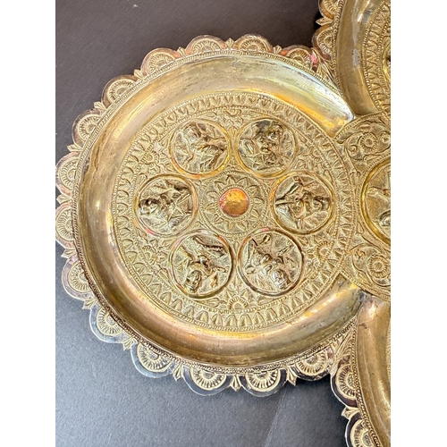 765 - An early 20th century Indian silver lobed dish with deities in relief, 7.3oz