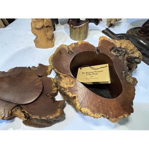A collection of carved wooden animals, elephant, python, giraffe, other ...