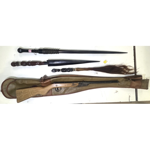 58 - An African carved ebony and horn stick, the horn smoothed into a tapering point, two other African i... 