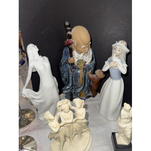 78 - A Chinese figure of a Sage with a small child; glass animal figures, Nao ducks and similar figures.