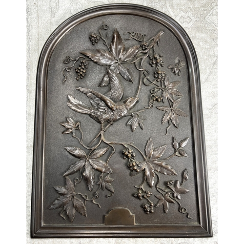 23 - A late 19th /early 20th century bronze plaque depicting a bird on a branch in relief with berries an... 