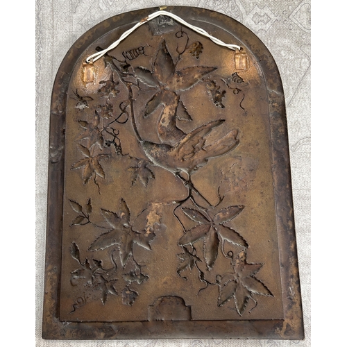 23 - A late 19th /early 20th century bronze plaque depicting a bird on a branch in relief with berries an... 