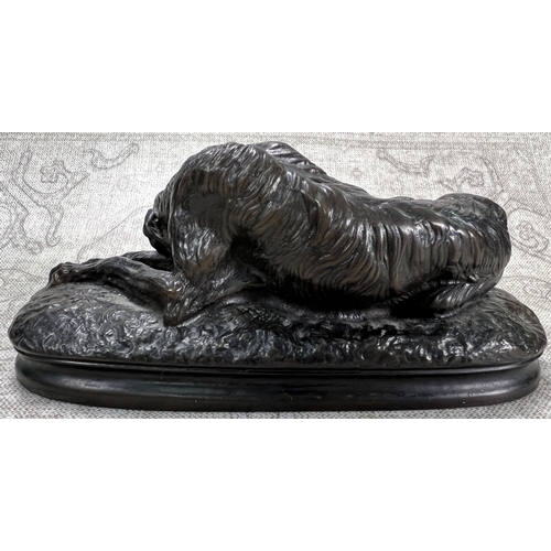 24 - A bronzed metal sculpture of a wolf hound, curled up, signed A Deva, length 16cm
