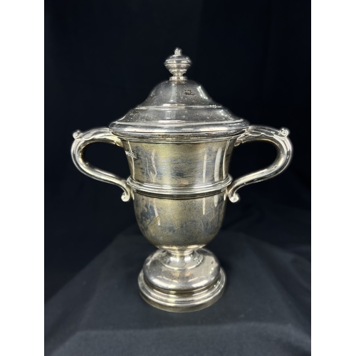 532 - A hallmarked silver twin handled covered trophy cup with circular pedestal base, Sheffield 1923, 13.... 