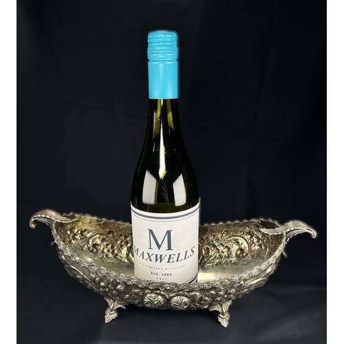 534 - A continental boat shaped 2 handled bowl with extensive embossed flowerhead and acanthus decoration,... 