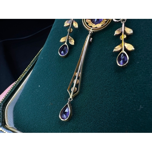 548 - An Art Nouveau pendant set with amethyst and seed pearls, stamped 9c on fine chain (pendant approx. ... 