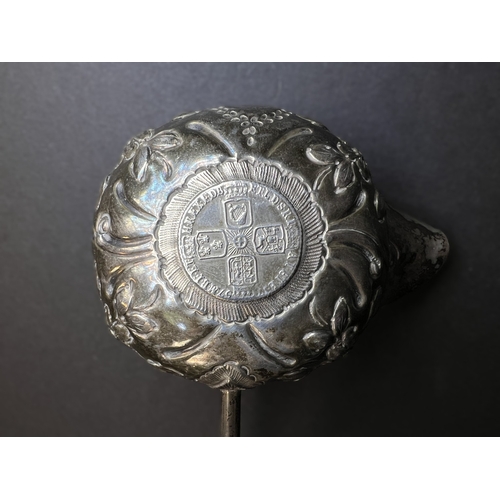 552 - An 18th century punch ladle with inset George II coin, with embossed decoration and twisted bone han... 