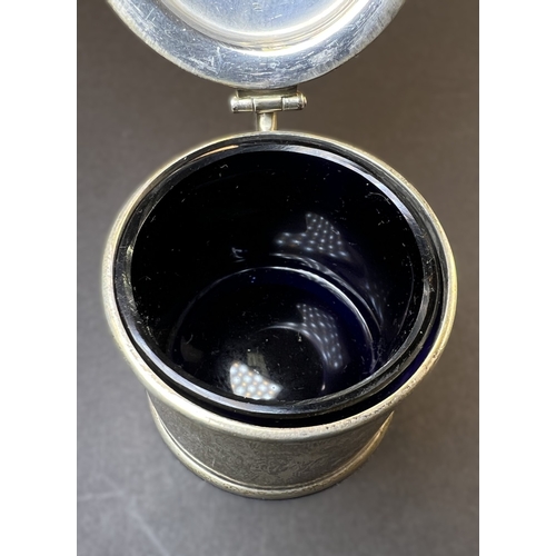 557 - A circular monogrammed mustard pot with blue glass liner, London 1898; a chased hallmarked silver ve... 