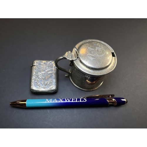 557 - A circular monogrammed mustard pot with blue glass liner, London 1898; a chased hallmarked silver ve... 
