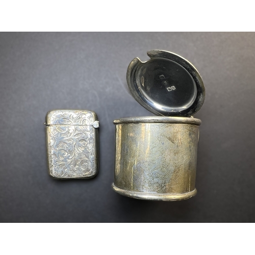 557 - A circular monogrammed mustard pot with blue glass liner, London 1898; a chased hallmarked silver ve... 