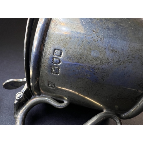 557 - A circular monogrammed mustard pot with blue glass liner, London 1898; a chased hallmarked silver ve... 