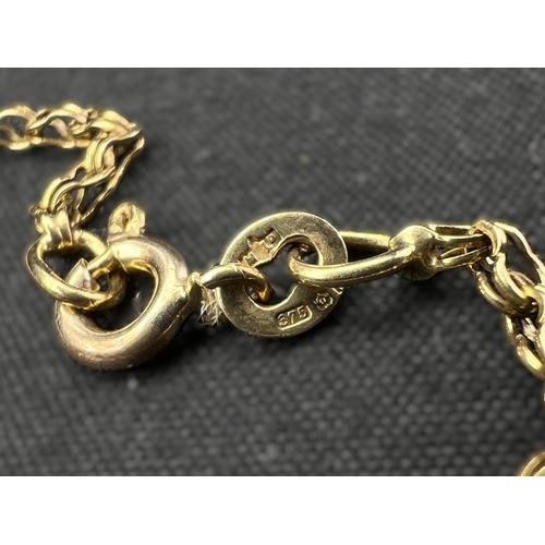 597 - A 9 carat hallmarked gold double link chain with cross stamped '9ct, 8.2gm, chain length 35cm