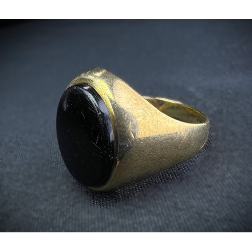 598A - A 9 carat hallmarked gold signet ring set oval black stone, size N, (shank slightly bent), 4.7gm