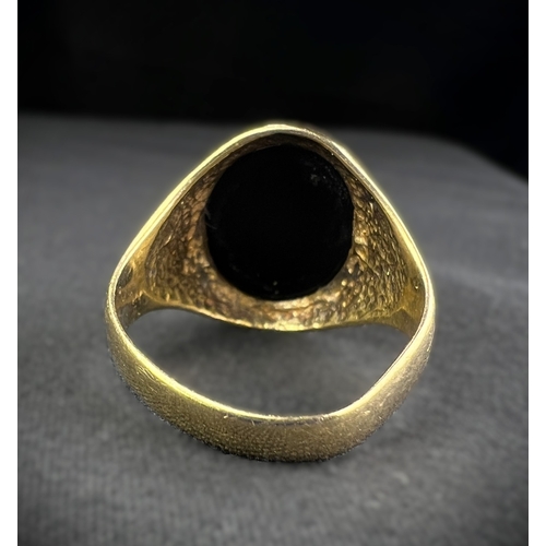 598A - A 9 carat hallmarked gold signet ring set oval black stone, size N, (shank slightly bent), 4.7gm