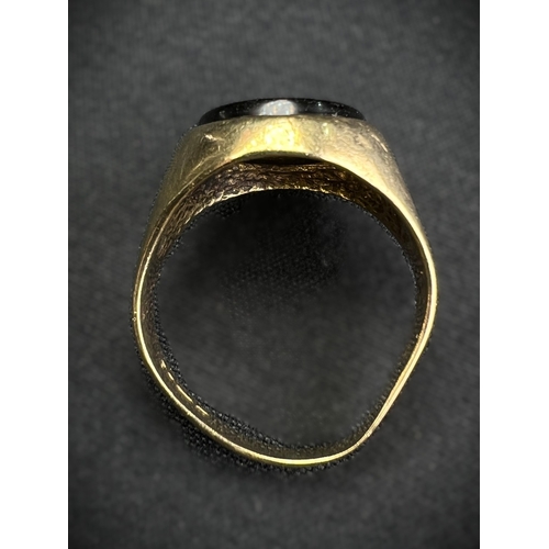 598A - A 9 carat hallmarked gold signet ring set oval black stone, size N, (shank slightly bent), 4.7gm
