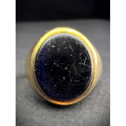 598A - A 9 carat hallmarked gold signet ring set oval black stone, size N, (shank slightly bent), 4.7gm