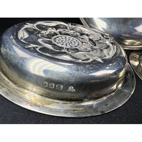 608 - A pair of small circular hallmarked silver dishes each decorated with a rose, London 1926; a small C... 
