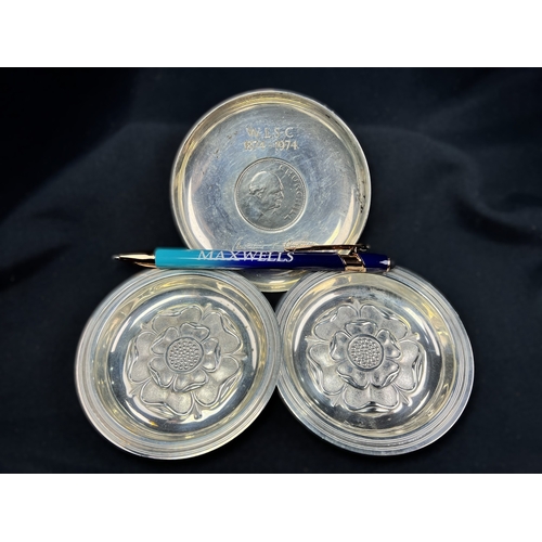 608 - A pair of small circular hallmarked silver dishes each decorated with a rose, London 1926; a small C... 