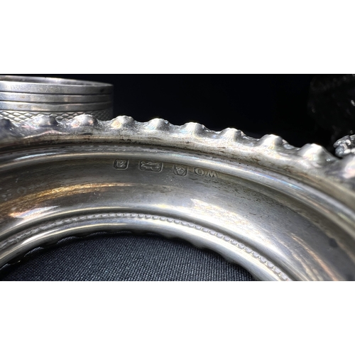 613 - A pair of chased hallmarked silver napkin rings; an engine turned pair of napkin rings; a hms salt o... 