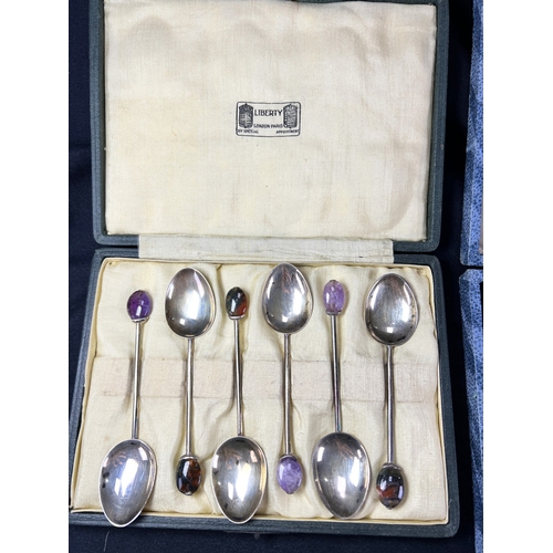 617 - A cased set of 6 hallmarked silver teaspoons by Liberty, Birmingham 1921, with amethyst 'bean knops'... 