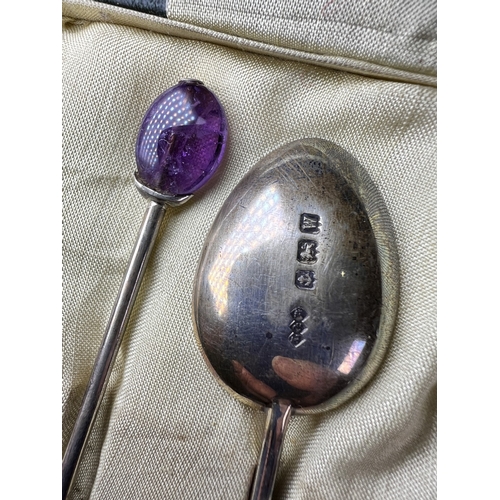 617 - A cased set of 6 hallmarked silver teaspoons by Liberty, Birmingham 1921, with amethyst 'bean knops'... 