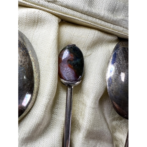 617 - A cased set of 6 hallmarked silver teaspoons by Liberty, Birmingham 1921, with amethyst 'bean knops'... 
