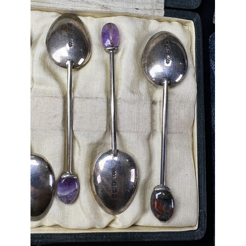 617 - A cased set of 6 hallmarked silver teaspoons by Liberty, Birmingham 1921, with amethyst 'bean knops'... 