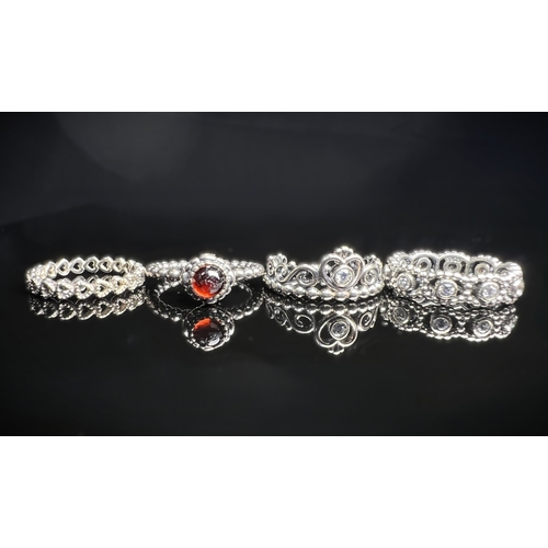 627 - Four silver Pandora rings, 3 with clear stones, sizes J & K, 11.7 gms.