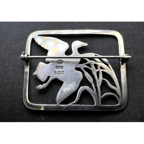 628A - GEORG JENSEN: a rounded rectangular silver brooch designed by Hugo Liisberg - a bird with outstretch... 