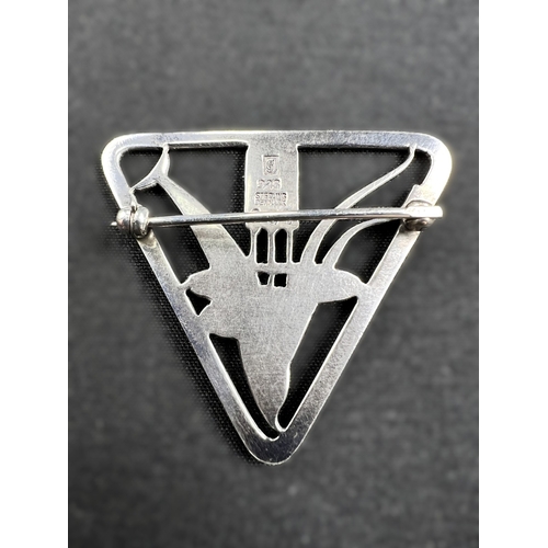 629 - GEORG JENSEN: a triangular silver brooch with dolphin diving through bullrushes, stamped to reverse ... 