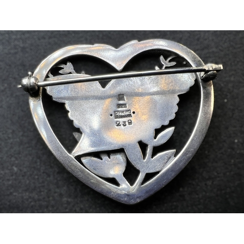 629D - GEORG JENSEN: a heart shaped silver brooch with bird in foliage, designed by Arno Malinowski, stampe... 