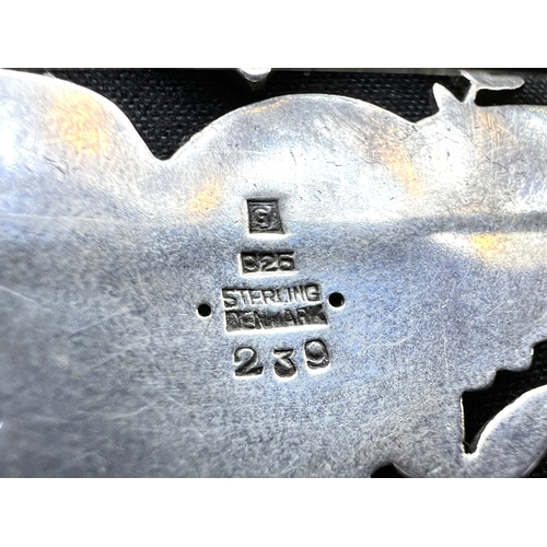 629D - GEORG JENSEN: a heart shaped silver brooch with bird in foliage, designed by Arno Malinowski, stampe... 
