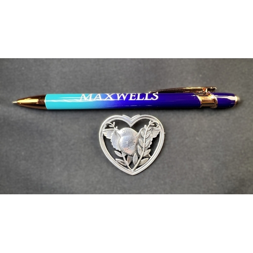 629D - GEORG JENSEN: a heart shaped silver brooch with bird in foliage, designed by Arno Malinowski, stampe... 