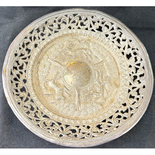 626 - A Far Eastern white metal shallow dish with extensive pierced relief decoration, on 4 ball feet, sta... 