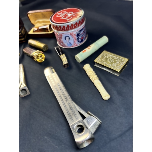 287 - A selection of cigar related items including amber and other holders, clippers etc.