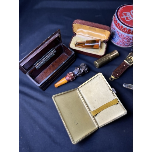 287 - A selection of cigar related items including amber and other holders, clippers etc.