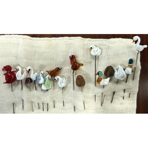 73A - A small collection of lace bobbins and glass hatpins