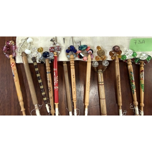 73A - A small collection of lace bobbins and glass hatpins