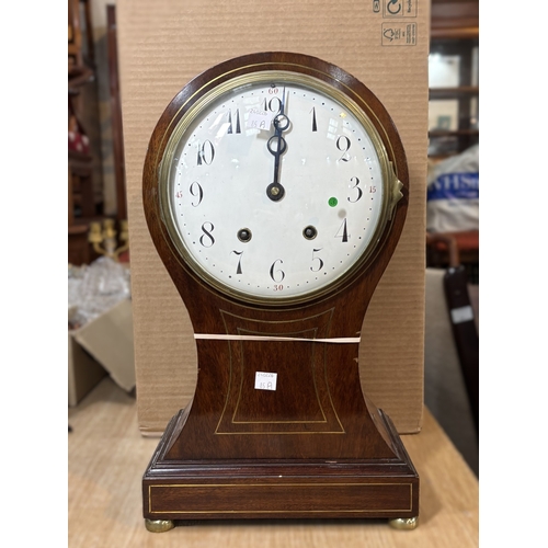 85A - An Edwardian inlaid mahogany balloon top mantel clock with white dial and striking movement
