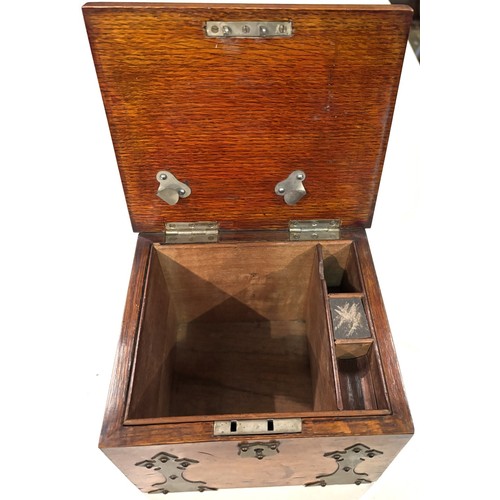 288A - A 1930's oak cigar humidor with brass fittings , match striking interior