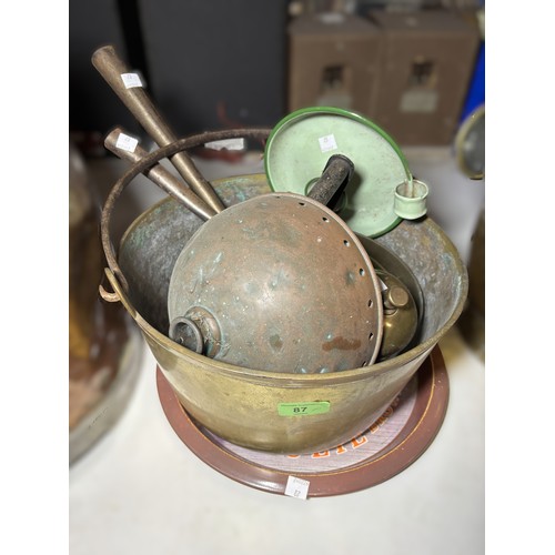 87 - A large brass jam pan and a selection of metalware.