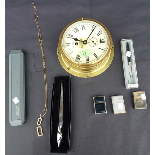 73 - A Smith brass cased ship's clock, lighters, pens etc.