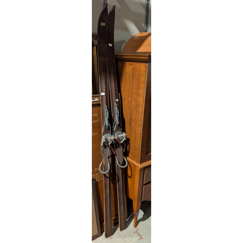 30 - A pair of vintage wooden skis in the manner of Lillywhites Sporting goods, with boot clips.