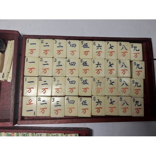 301 - A vintage Mahjong set, boxed; 2 large conch shells, other games etc.